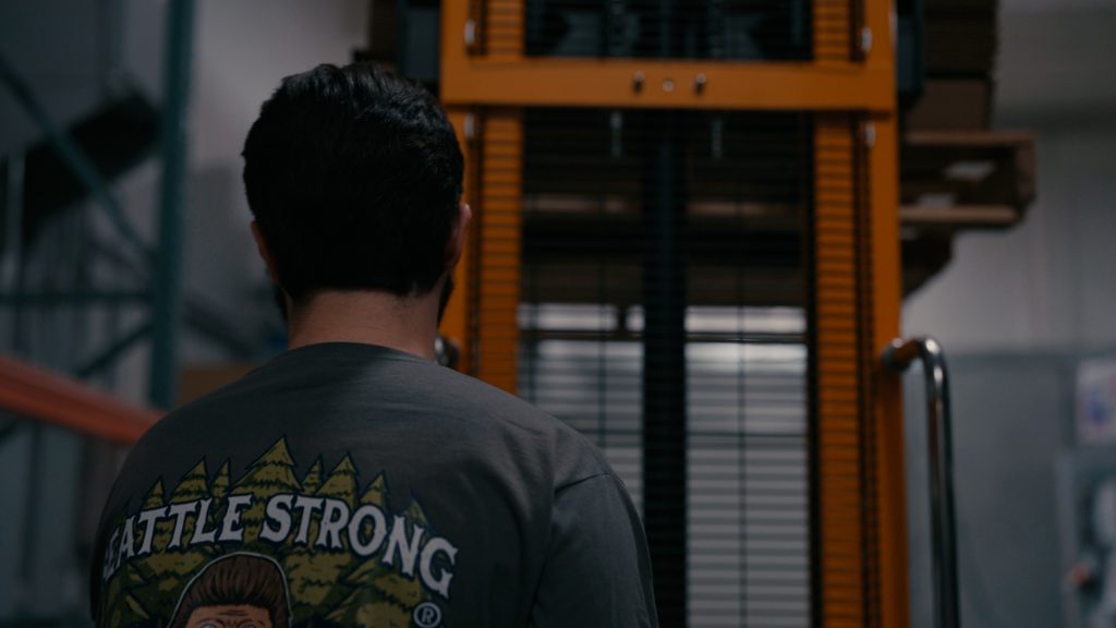 Man in warehouse operating forklift