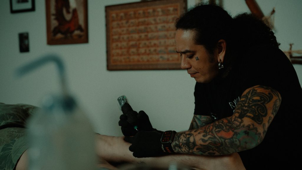 Man tattooing a leg